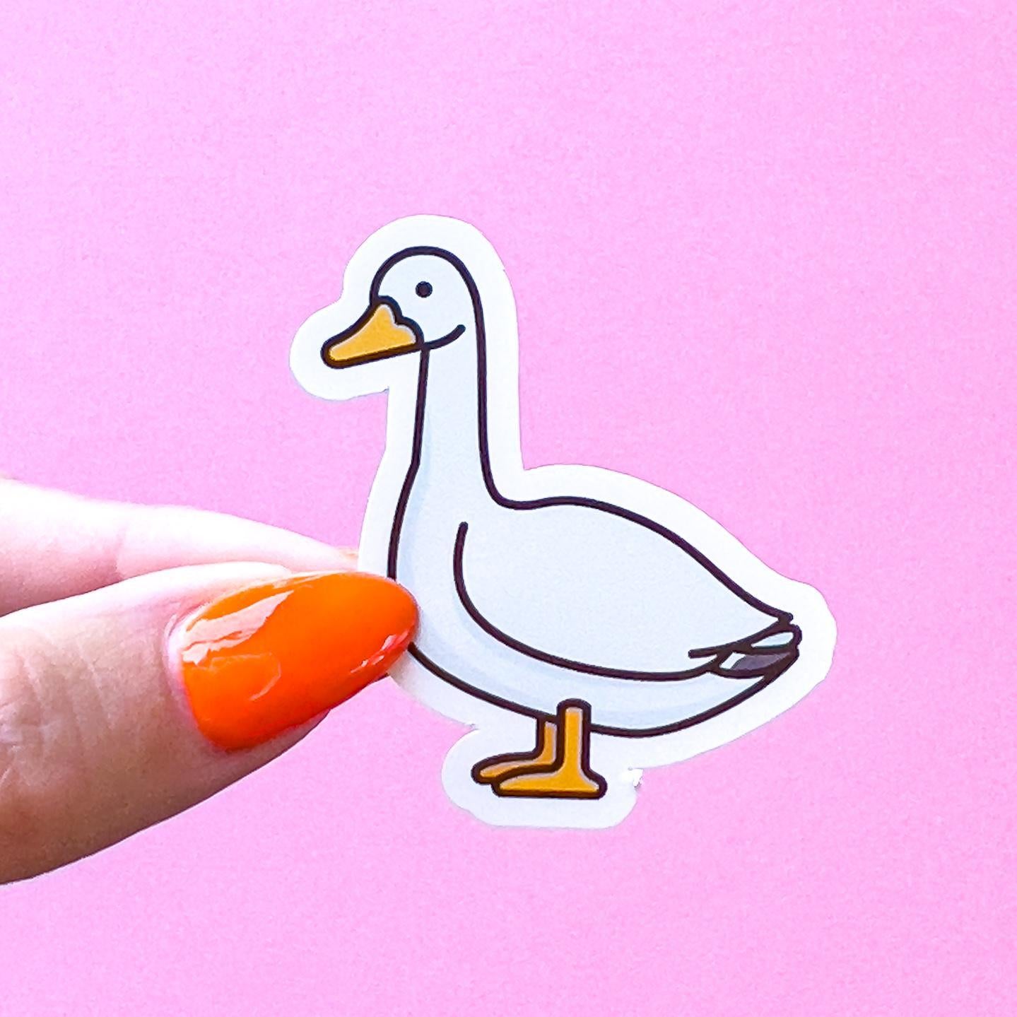 A vinyl decal sticker of a white goose/duck with a yellow beak and feet standing sideways.