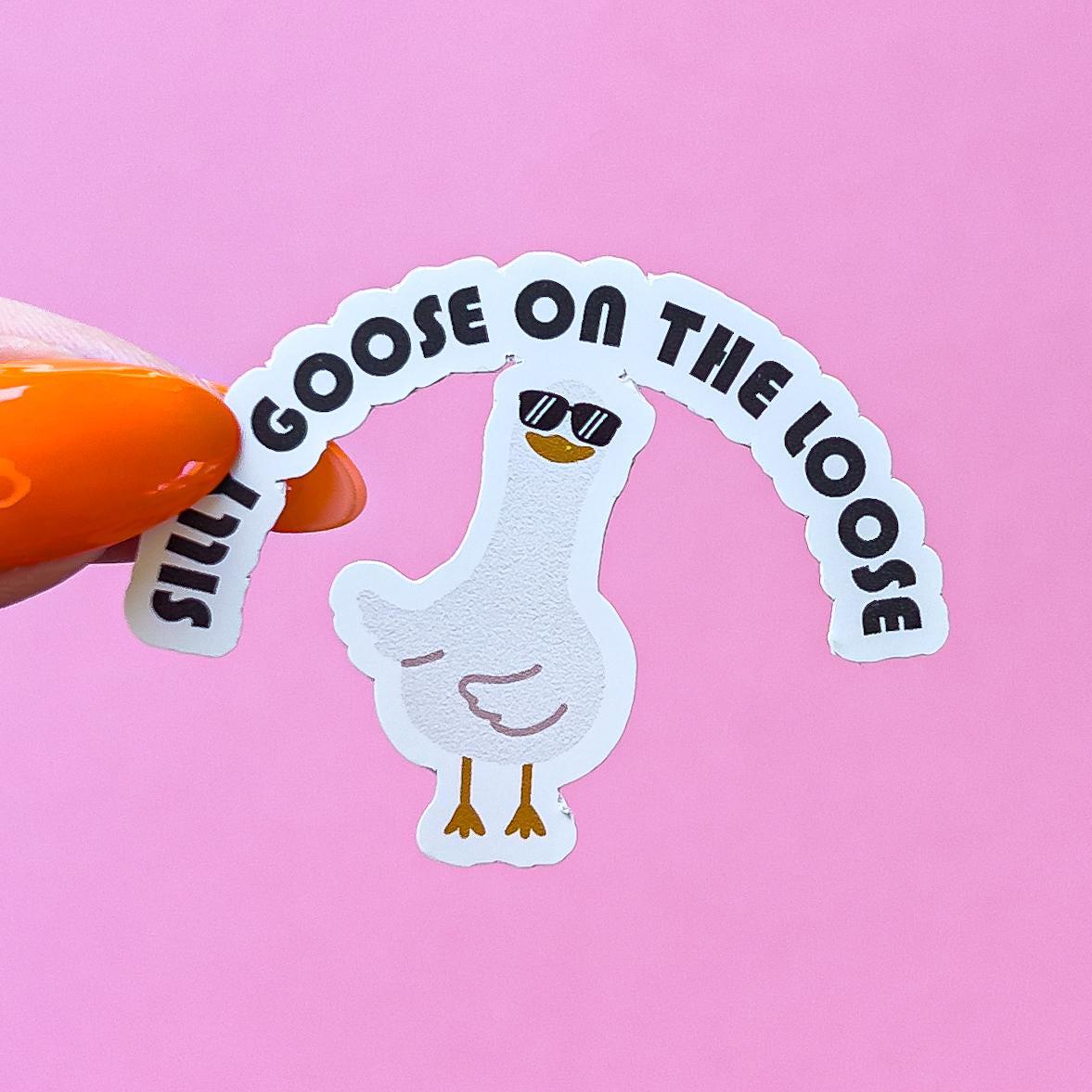 A vinyl decal sticker of a white goose wearing sunglasses with the text 'Silly Goose on the Loose' in a black semi-circle above the goose. The goose is dancing with its wings to one side.
