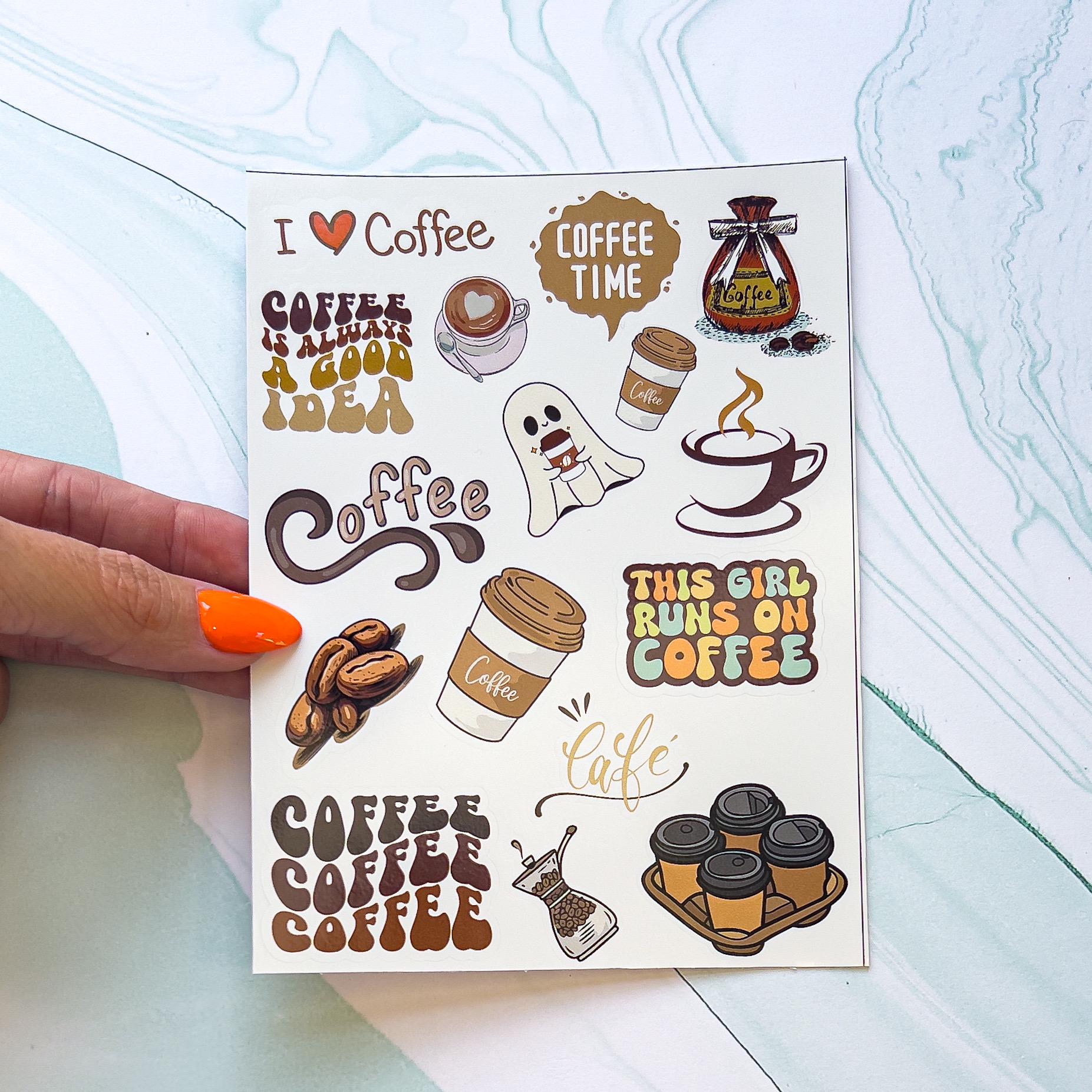 A sheet of coffee themed vinyl decal stickers. The stickers include "I <3 Coffee" in a hand written style text, "This girl runs on coffee" in orange, yellow, green, and blue styled font surrounded by brown, coffee beans, to go coffee cups, a ghost holding a coffee cup, a bag of coffee beans, a steaming coffee mug in minimalist style, "COFFEE COFFEE COFFEE" in a styled gradient text, and "COFFEE IS A GREAT IDEA" in a styled gradient text.