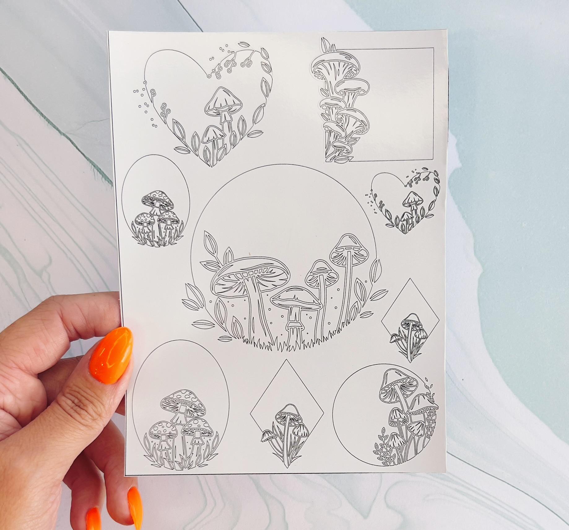 A sheet of various black line drawings of mushrooms and leaves. The mushrooms are drawn in different shapes and sizes, and some of them are clustered together. The leaves are drawn in a variety of shapes and sizes, and some of them are clustered together. The drawings are arranged in a variety of patterns, and some of them are surrounded by circles, hearts, and diamonds.