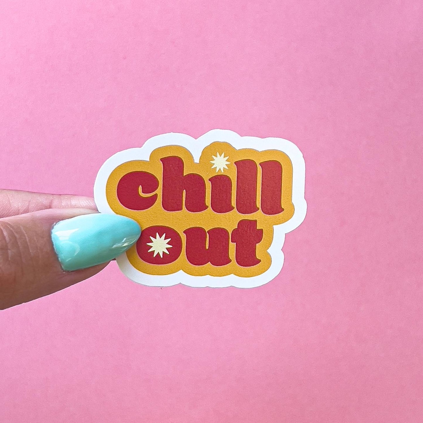 A vinyl decal sticker with a rounded edge, featuring the words 'chill out' in red  letters surrounded by orange with a white star in the middle of the word 'out'.