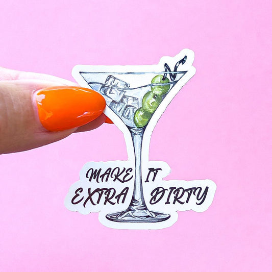 A vinyl decal sticker of a martini glass with green olives and ice. The text reads 'Make it extra dirty' in cursive font.