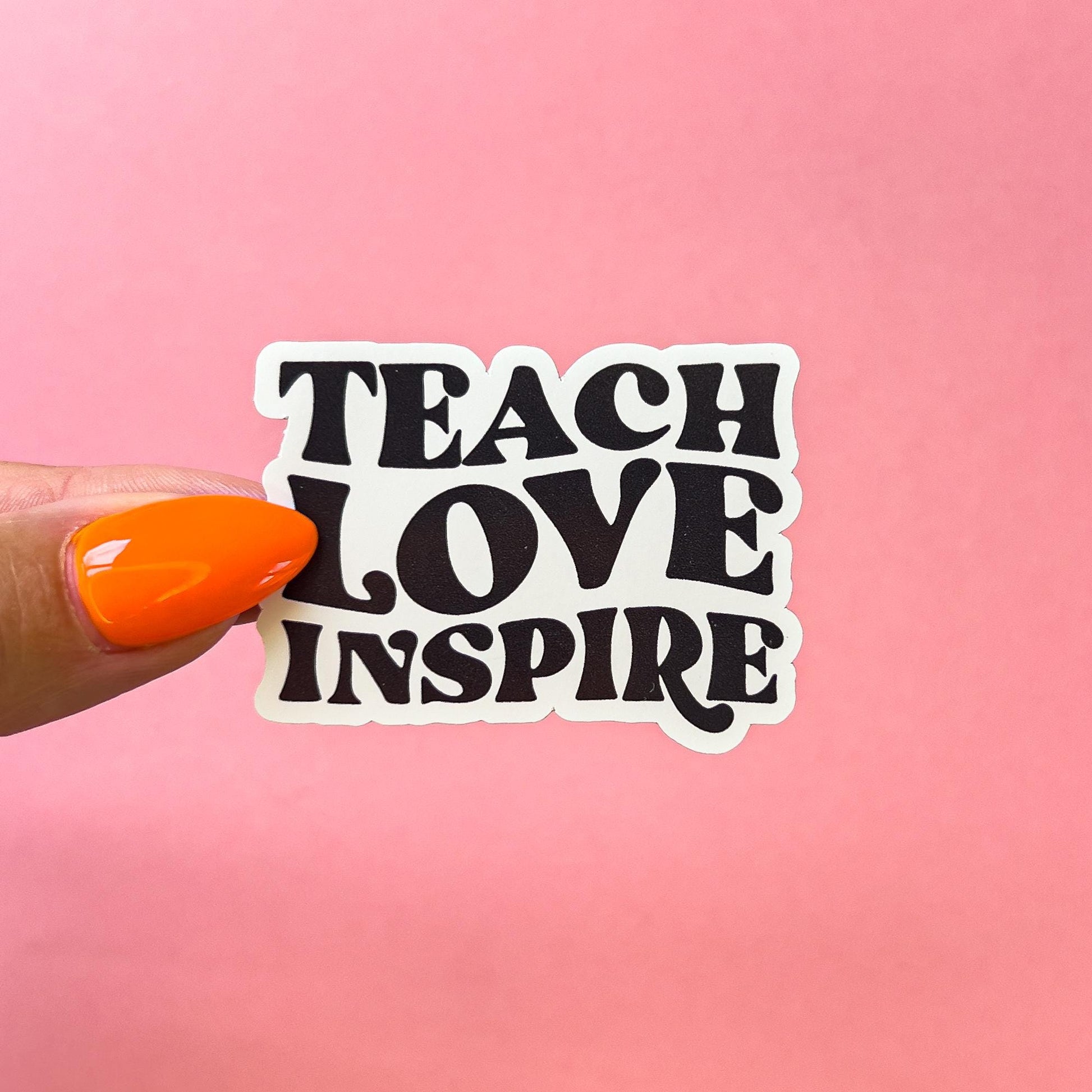 A vinyl decal sticker with the words 'TEACH LOVE INSPIRE' in black, retro font.