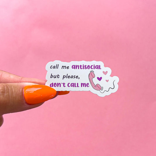 A vinyl decal sticker with black and purple text, a pink phone graphic, and purple and pink hearts. The text reads 'call me antisocial but please, don't call me'.