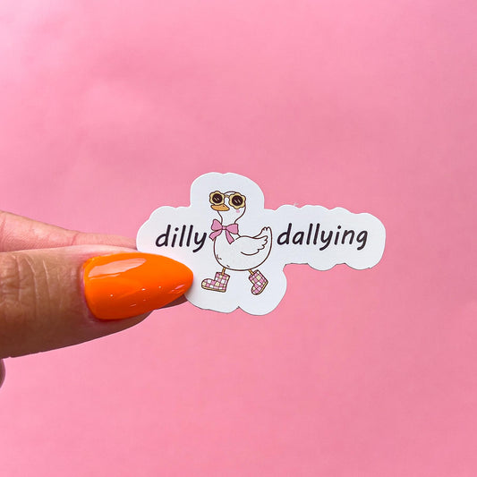 A vinyl decal sticker of a white goose/duck wearing yellow sunglasses and a pink bow tie, walking in pink and white checkered boots. The goose is in a walking pose. The words 'dilly dallying' on either side of the goose.