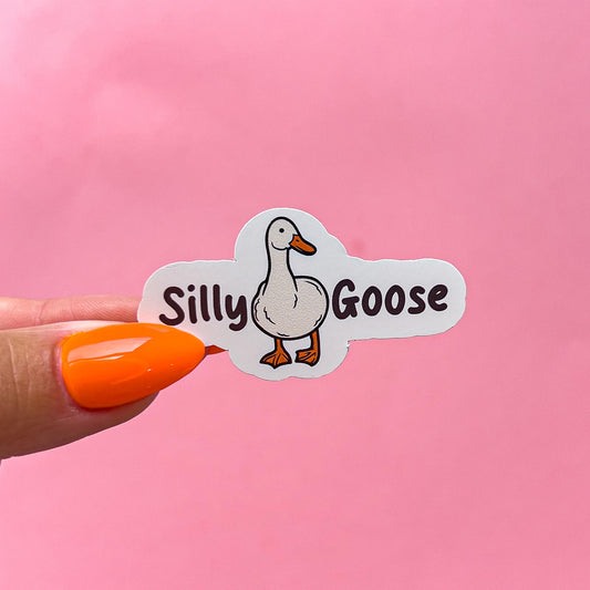 A vinyl decal sticker with of a white goose with orange beak and feet and the text 'Silly Goose'.