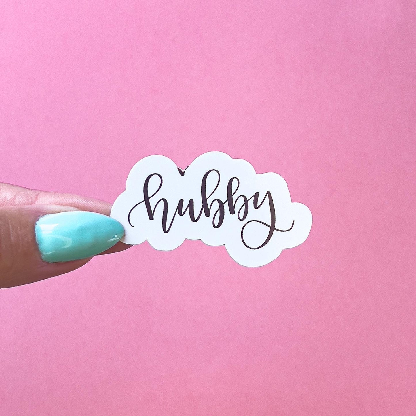 A vinyl decal sticker of cursive text that reads "hubby".