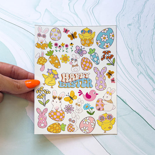 A sheet of Easter themed vinyl decal stickers. The stickers include "HAPPY EASTER" in blue, orange, and cream colored stylized font, Easter eggs and carrots with different patterns including flower, checkered, polka dot, and stars, birds, flowers in multiple colors, bunnies and chicks wearing sunglasses and dancing or posing on Easter eggs, and butterflies. The colors are pastel pink, blue, green, purple, orange, yellow, and white.