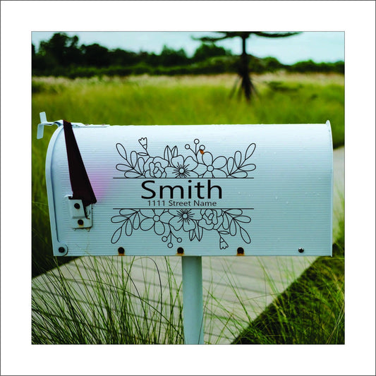 A custom vinyl decal sticker for mailbox with a black floral design and the name 'Smith' and street address printed on it, this would be replaced with your name and address.