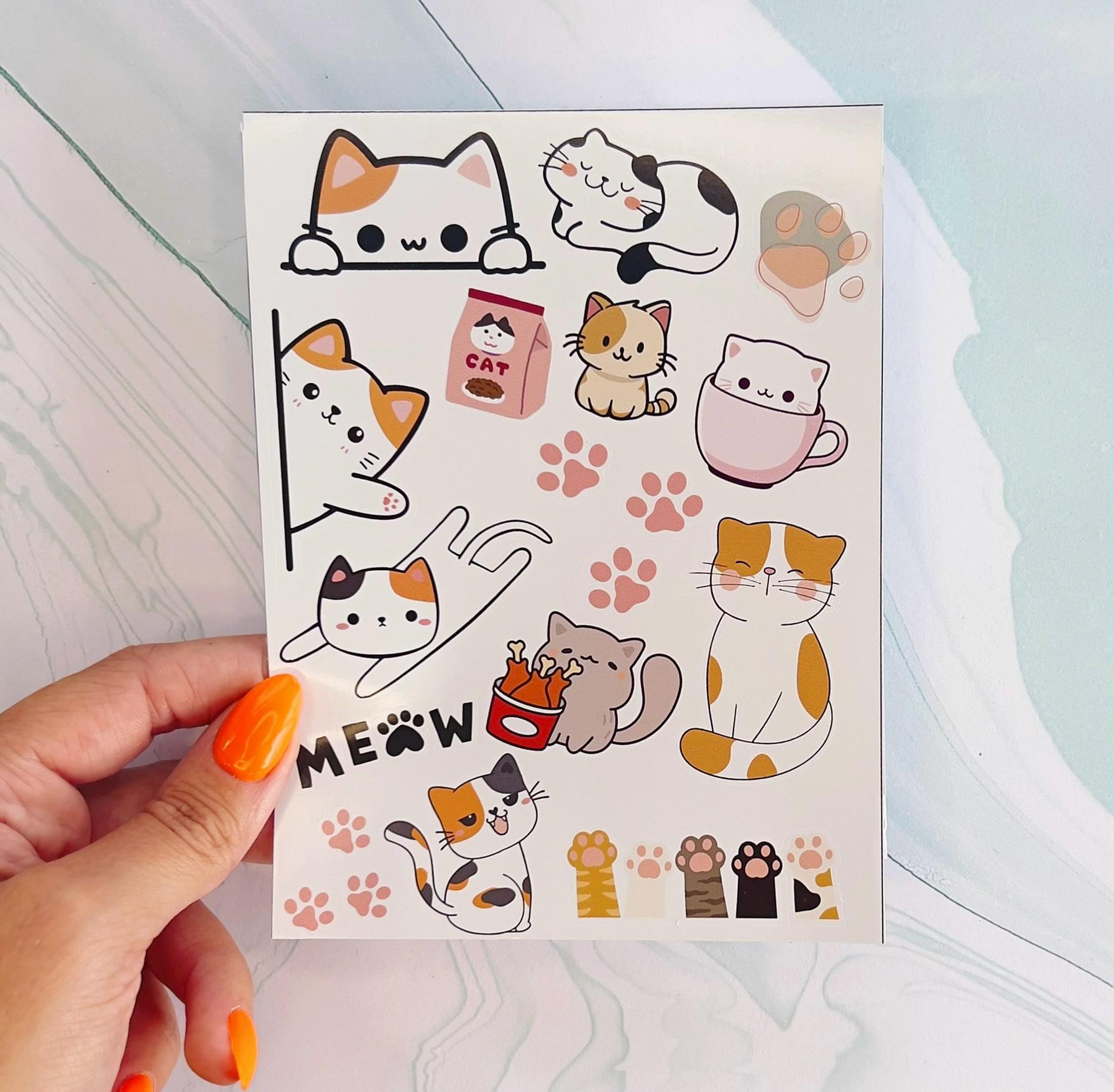 A vinyl sticker sheet featuring cartoon cats, paw prints, cat paws, and the word meow. The cats are in various poses and colors including: white, black, orange, grey, and brown. The paw prints are light pink. The word "MEOW" is black and the "O" is a paw print.