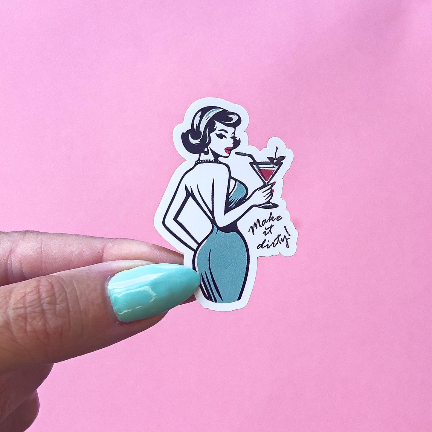 A vinyl decal sticker of a vintage, pinup woman in a blue dress holding a martini cocktail glass. The text on the sticker reads 'Make it dirty!'