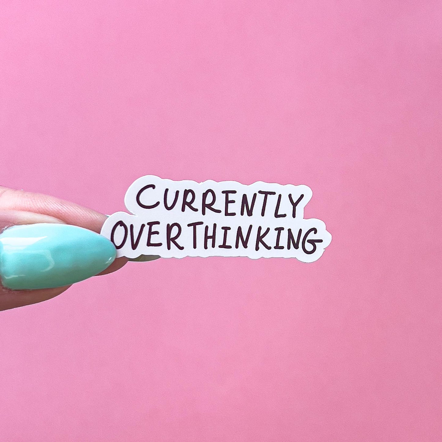 A vinyl decal sticker with black text that reads 'Currently Overthinking'