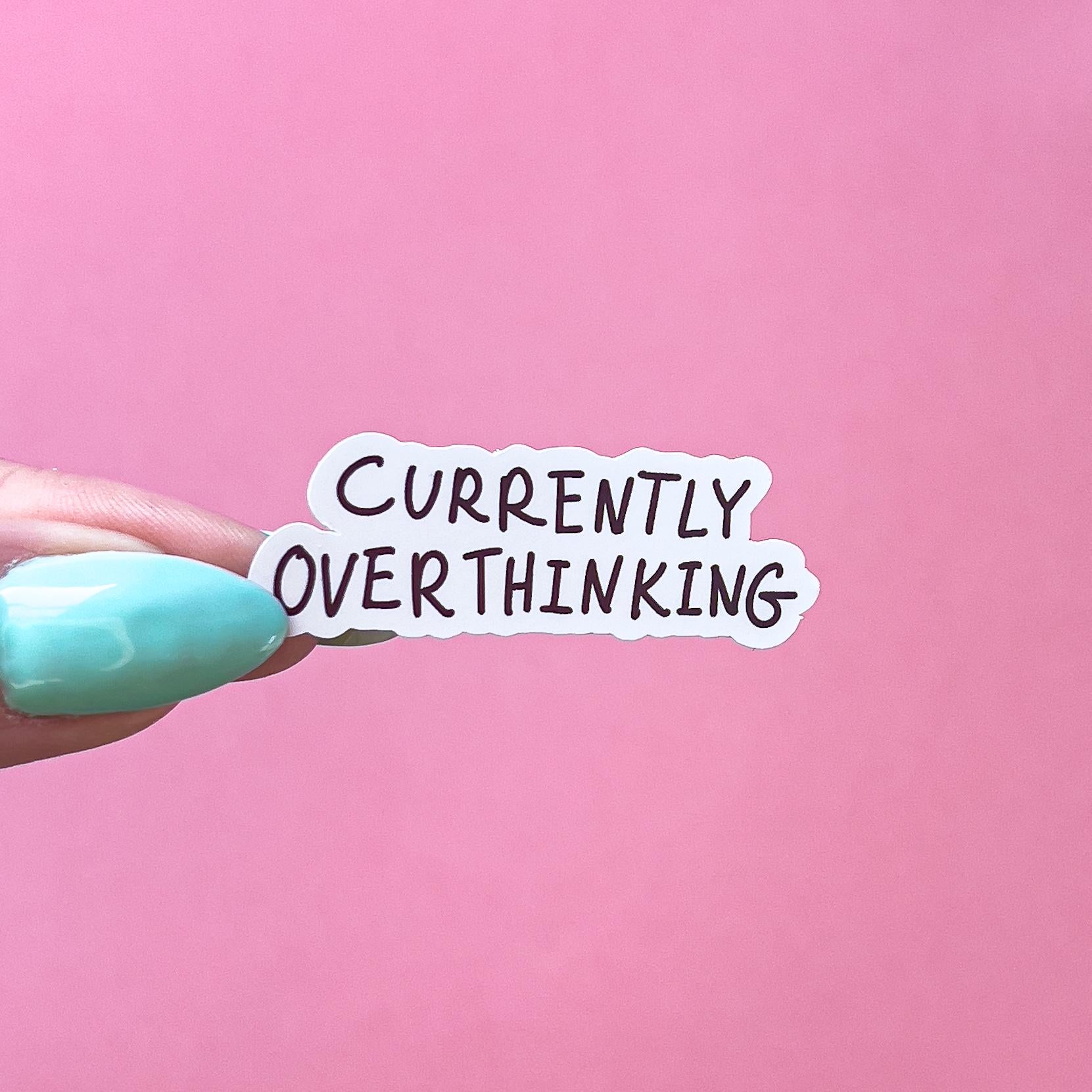 A vinyl decal sticker with black text that reads 'Currently Overthinking'
