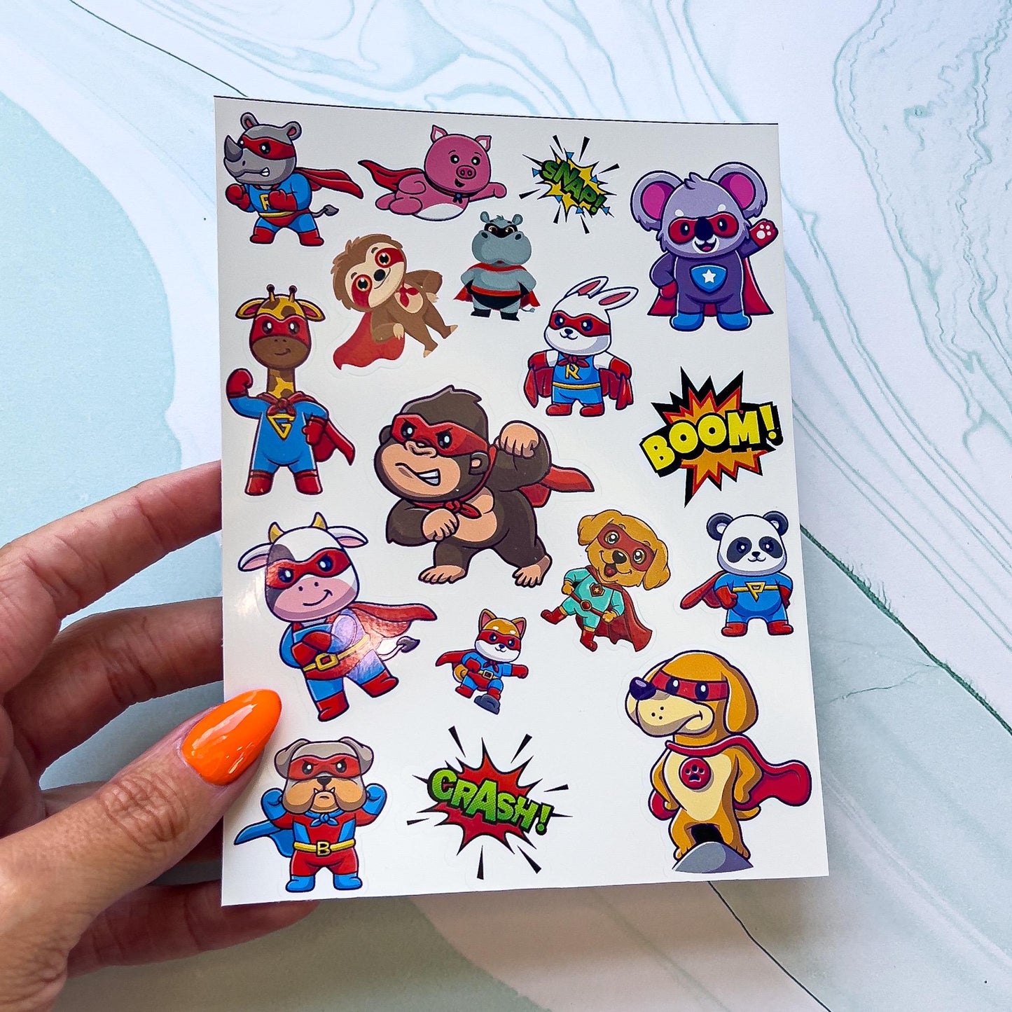 A sheet of various superhero stickers. The stickers are various animals dressed as super heroes and comic book style words. The words include "BOOM" and "CRASH"