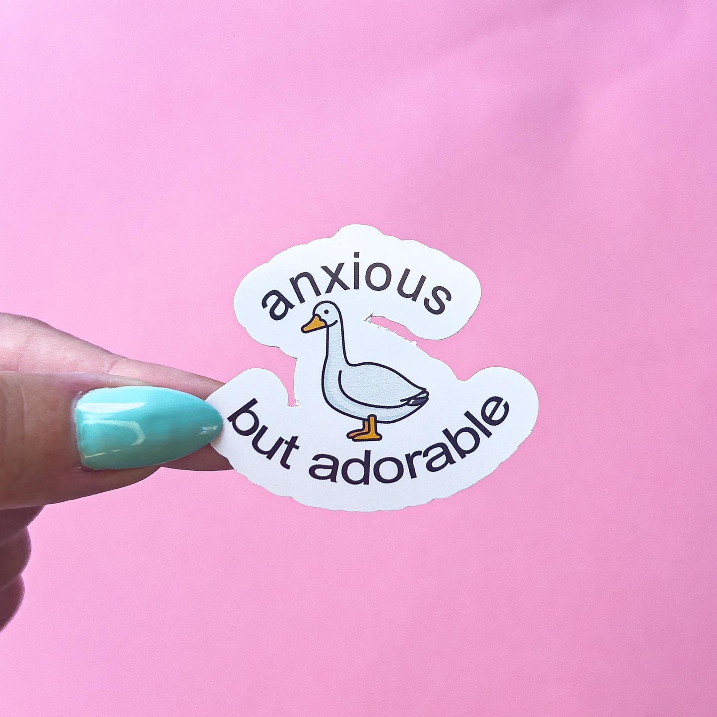 A vinyl decal sticker of a green cartoon goose/duck with the text 'anxious but adorable'.