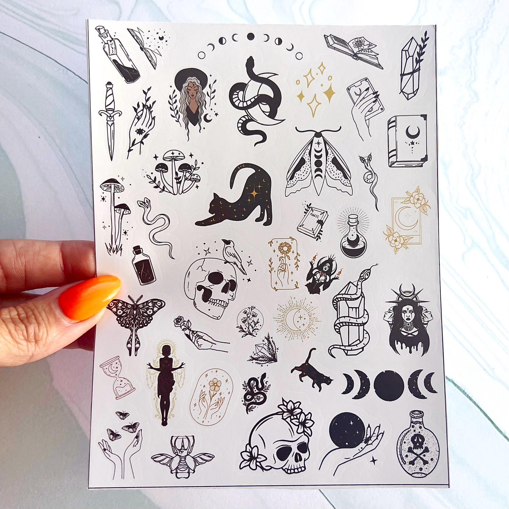 A sheet of black, white, and gold stickers with a witchy/ astrology theme. The stickers feature images of moons, stars, snakes, skulls, butterflies, cats, mushrooms, flowers, and other witchy symbols.