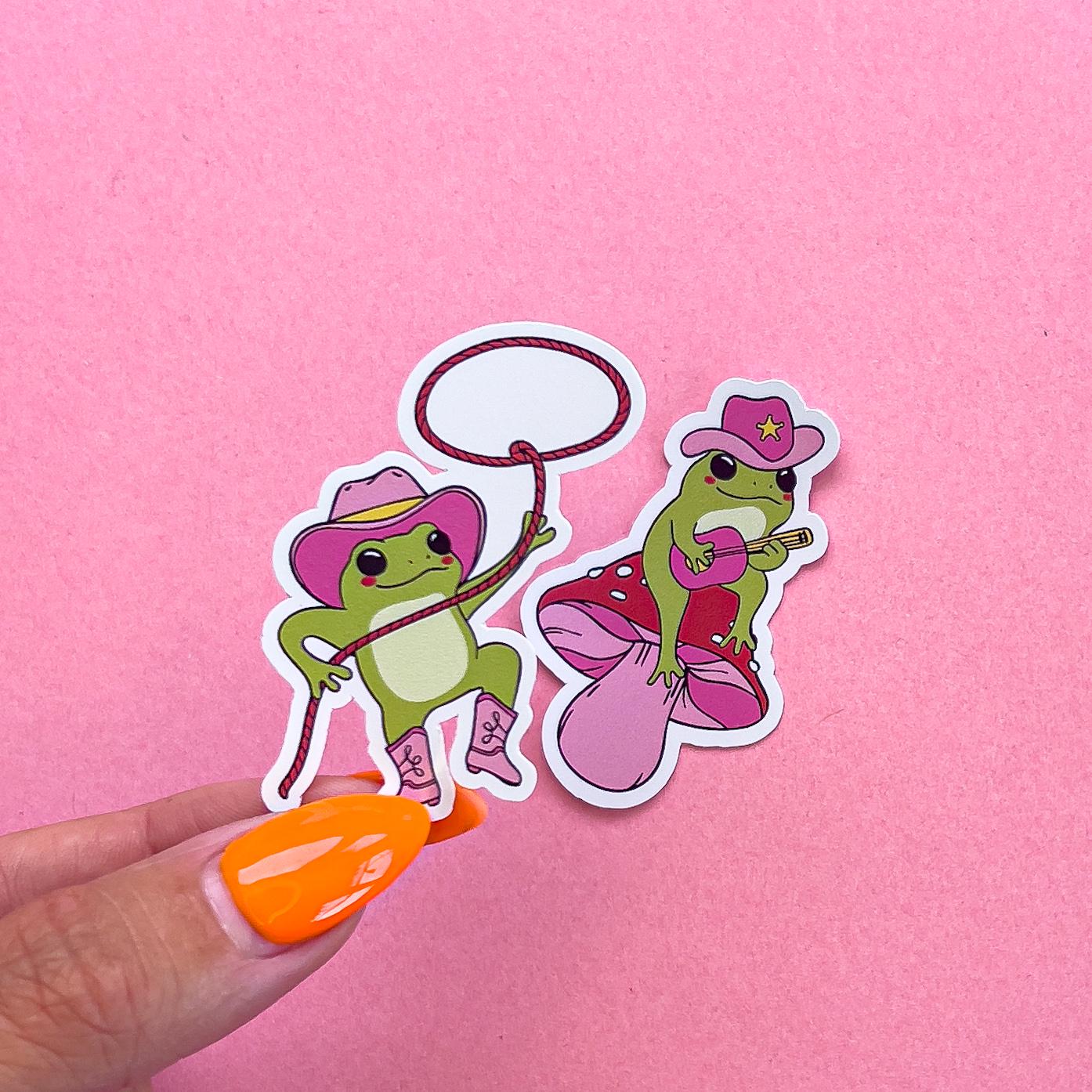 Vinyl decal stickers of cartoon frogs dressed in pink cowboy/country theme.