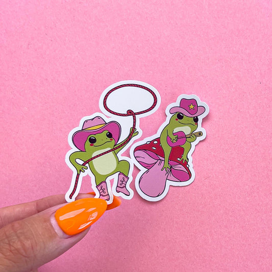Vinyl decal stickers of cartoon frogs dressed in pink cowboy/country theme.