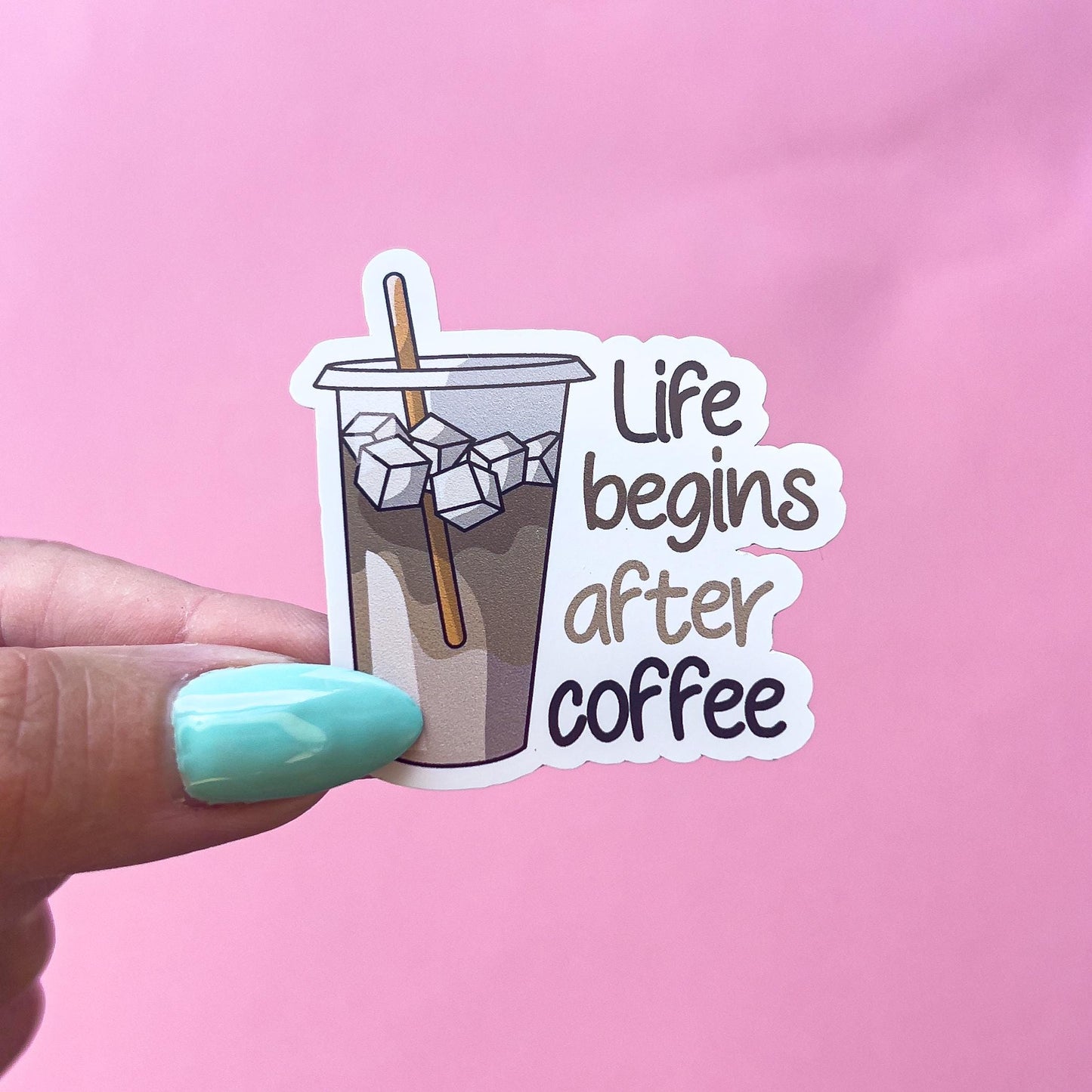 A vinyl decal sticker of a beige and brown iced coffee cup. The text is brown, beige, black and reads “life begins after coffee”.