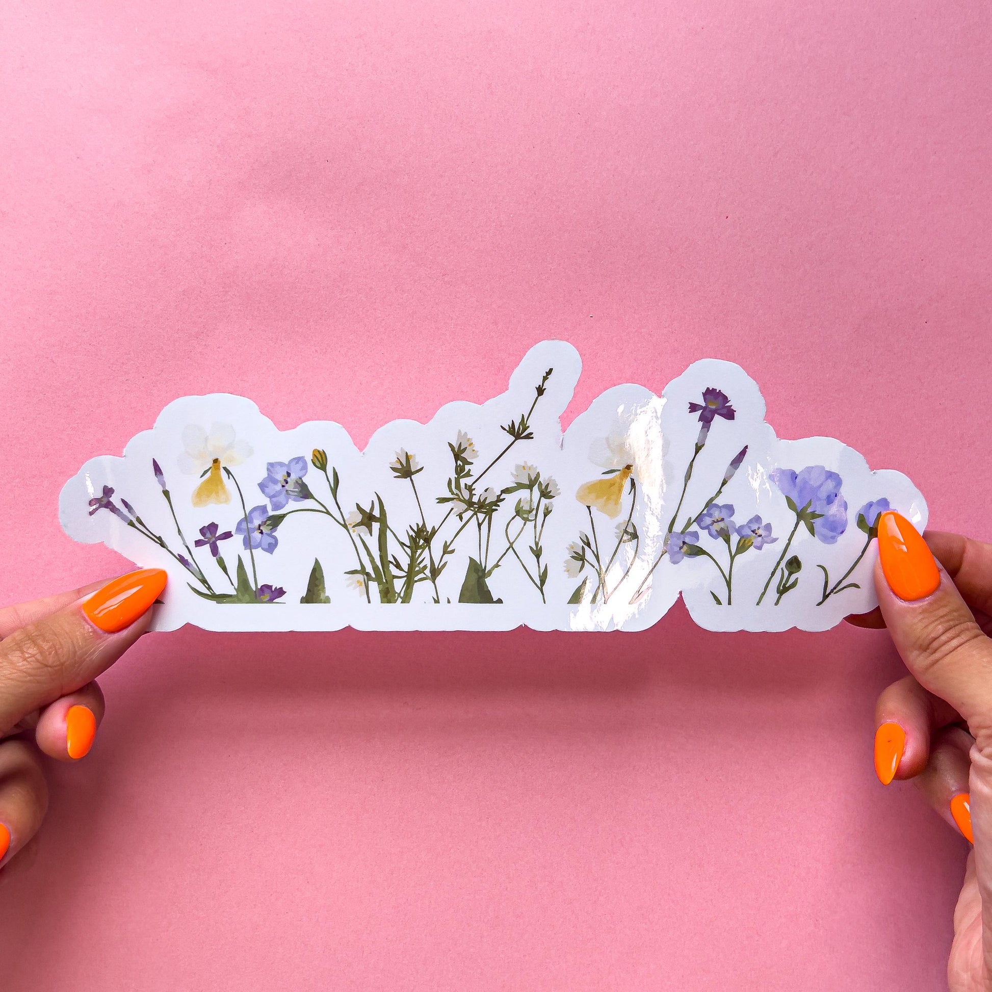 A vinyl decal sticker colorful wildflower border on clear vinyl. Includes yellow, purple, blue and green colors.