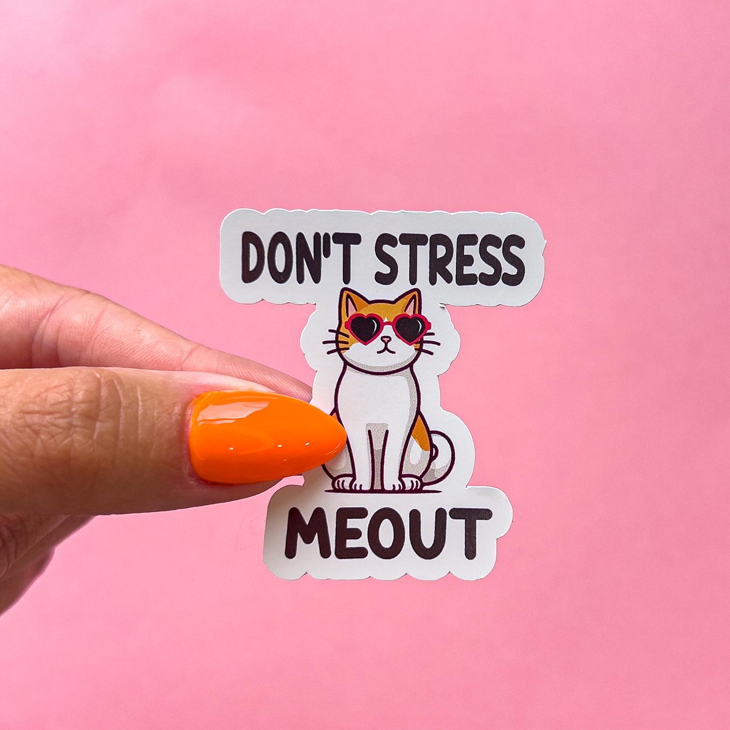 A vinyl decal sticker with a cartoon cat wearing red, heart-shaped sunglasses. The text on the sticker reads 'Don't Stress Meout'.