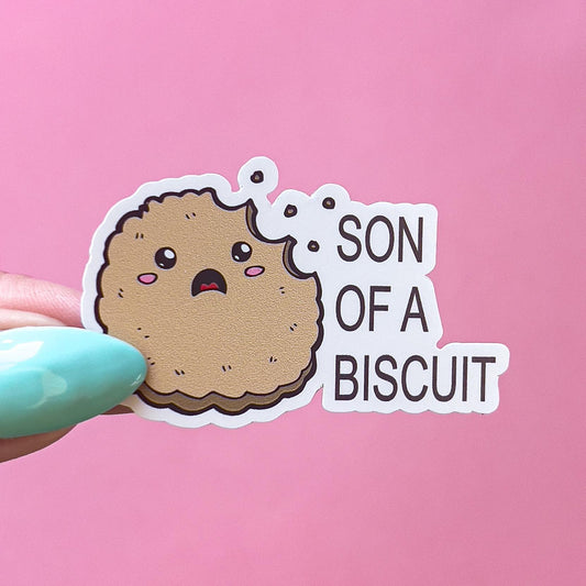 A vinyl decal sticker with a brown cartoon biscuit with a bite taken out of it. The biscuit has a surprised expression with open mouth and blushed cheeks. The text on the sticker reads 'SON OF A BISCUIT'.