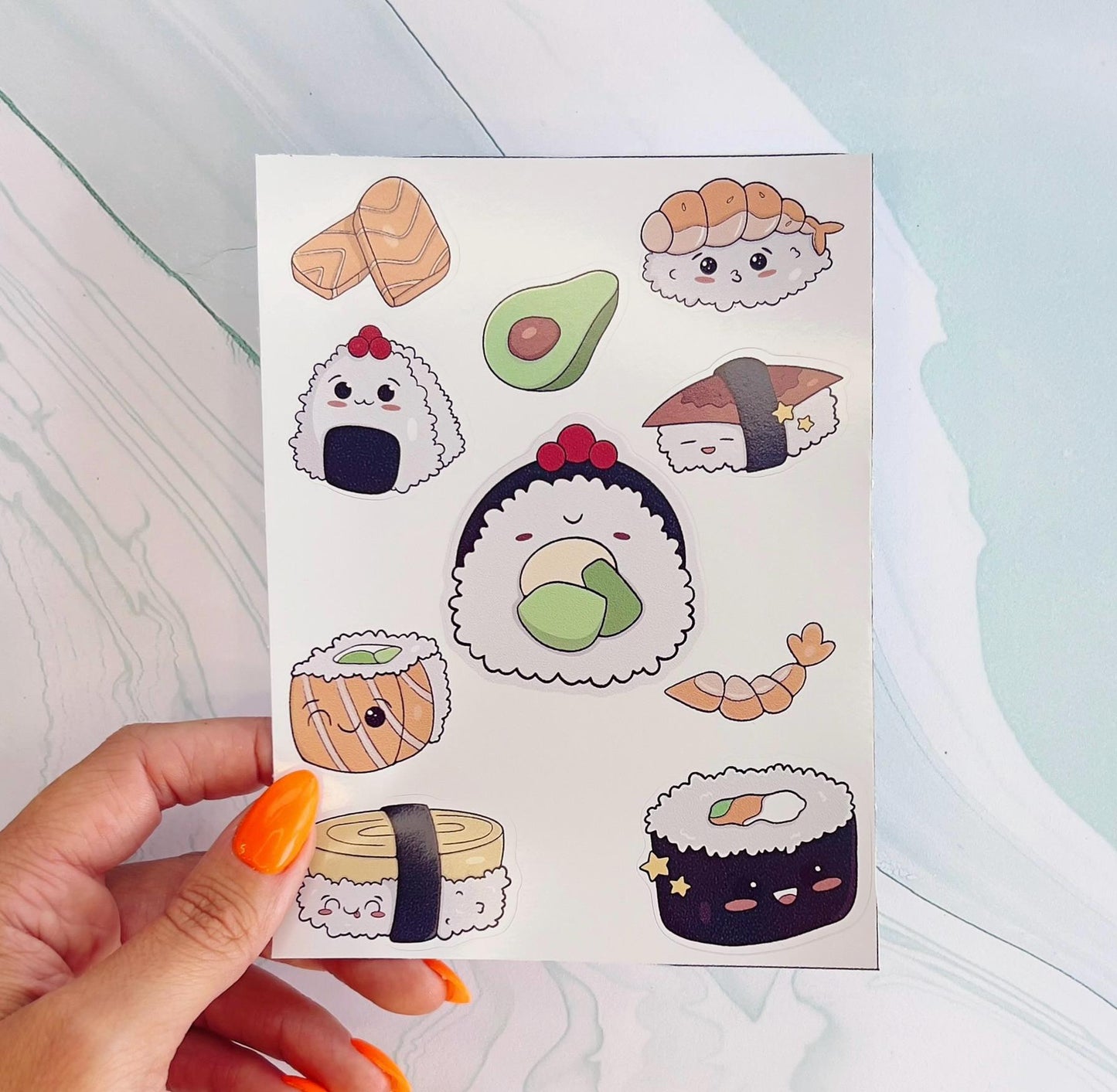 A sheet of stickers featuring various cartoon kawaii sushi rolls, a shrimp, and and avocado. The sushi rolls are illustrated with cartoon faces and have different fillings.